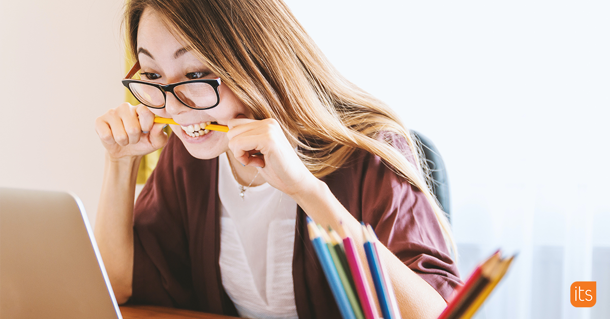 Photo of an anxious student biting their pencil while studying.
