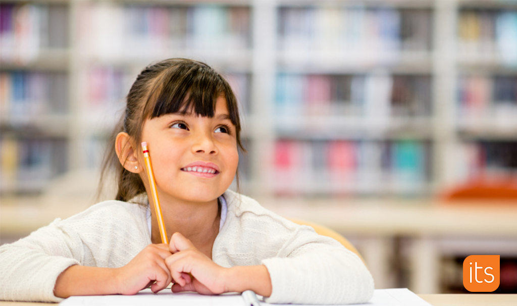 a girl holding a pencil and smiling